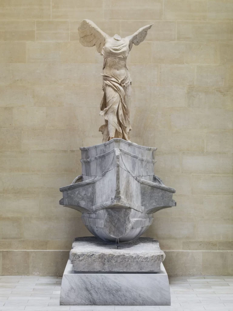 Winged Victory of Samothrace sculpture on the grand staircase of the Denon Wing, Louvre Museum